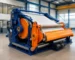 Blue and orange Rotocure rotary curing machine in a rubber manufacturing workshop