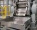 Rubber dispersion kneader discharge area and receiving tray