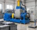 Illustrative rubber dispersion kneader beside closed material trays and a floor scale